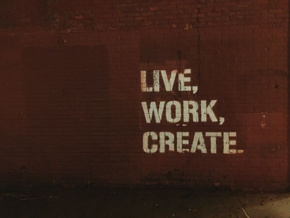 Startup Business - red brick wall with live, work, create. quote