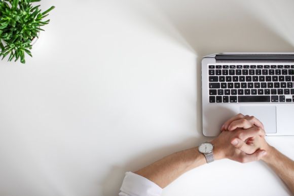 Online Business - person wearing watch near laptop