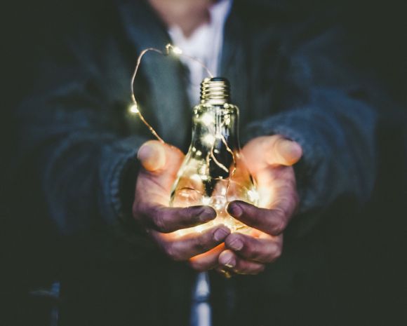 Entrepreneurship - man holding incandescent bulb