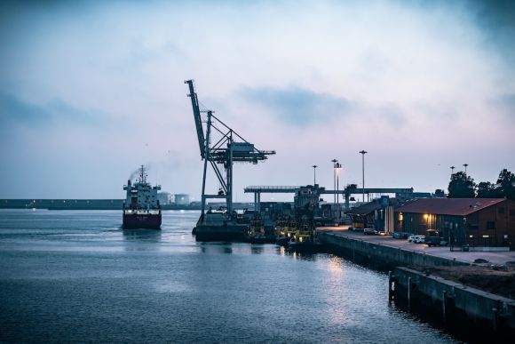 International Trade - blue crane on dock during daytime