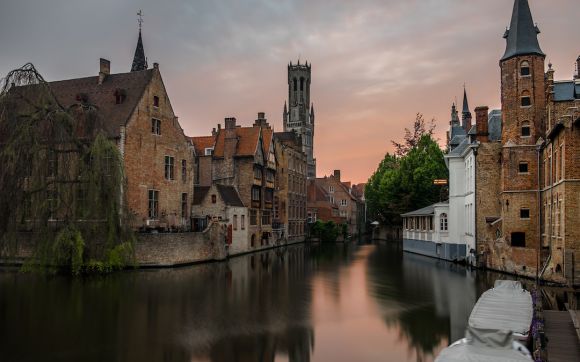 Belgium - brown concrete buildings beside calm body of water