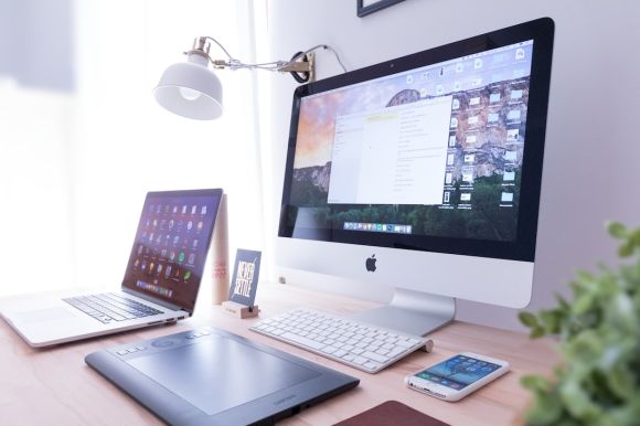 Online Business - silver iMac near iPhone on brown wooden table